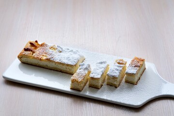 Cottage cheese casserole and tea against a dark background. Selective focus. The image is tinted. High quality photo