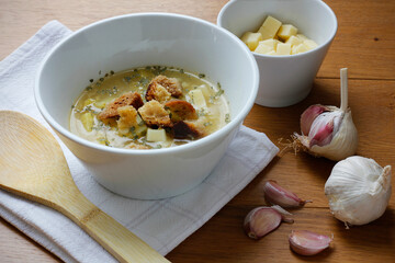 Bowl of a traditional Czech and Slovak garlic soup (called cesnecka or oukrop) cooked from broth,...