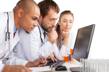Portrait of Doctors Looking at Laptop and Writing on Clipboard
