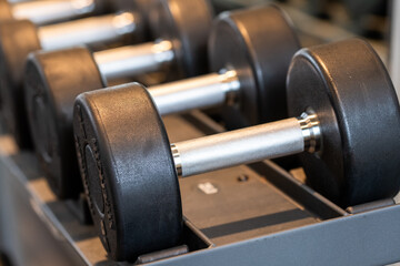 Close up of Dumbbells on weight rack in workout room