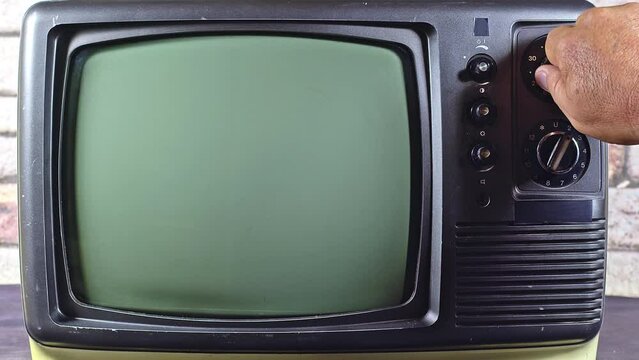 Man Hand Tuning Old Television With Gray Interference Screen Channel Footage.