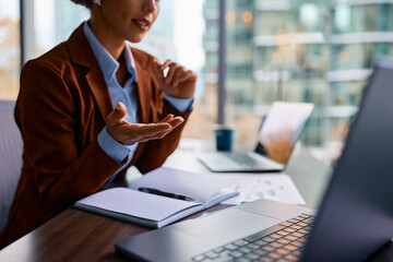 Close up of businesswoman talking during conference call in office.