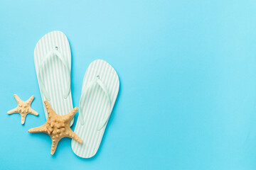 Striped flip flops on color background, top view
