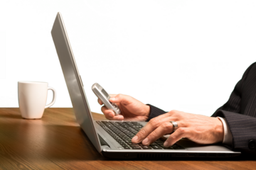 Closeup on a Businessman Working with Laptop while Using a Mobile Phone