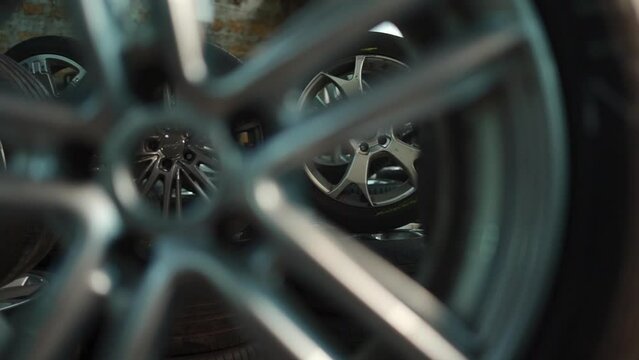 modern warehouse with stack of car tires with metal disk, auto repair service