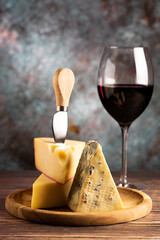 Cheese board with a glass of red wine.