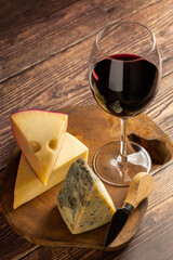 Cheese board with a glass of red wine.