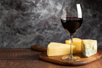 Cheese board with a glass of red wine.
