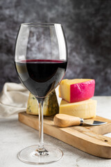 Cheese board with a glass of red wine.