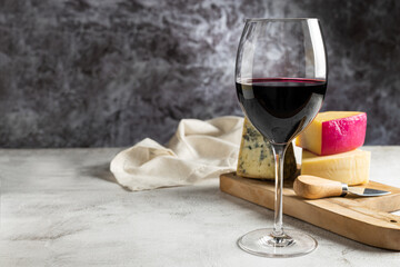 Cheese board with a glass of red wine.