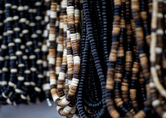 Handmade Multicolored Wooden Beaded Necklaces hanging on a Rack