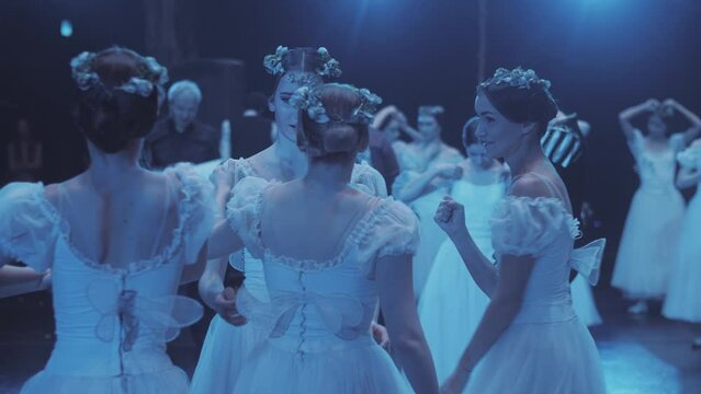 Friendship and support in ballet. Ballerinas congratulate each other after the premiere of the ballet performance.