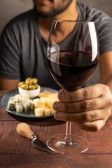 Man tasting wine and cheese.