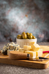 Plate of various cheeses on the table. Pieces of cheese.