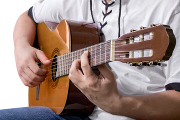 Man playing guitar against white background.