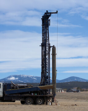 Well drilling equipment in a developing suburban area of a rural community.