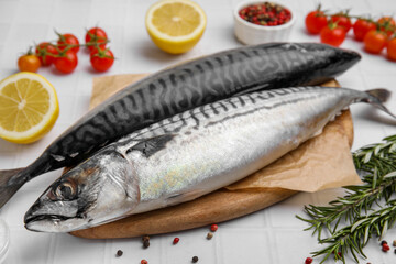 Raw mackerel and rosemary on white table