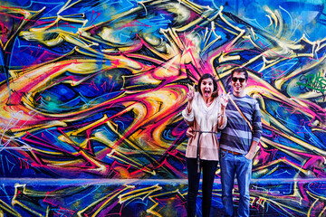 Young Couple in Fitzroy Quartier, an inner-city suburb of Melbourne, with its street art, music...