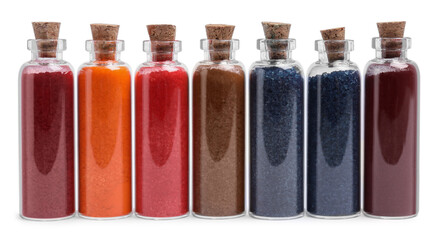 Glass bottles of different food coloring isolated on white