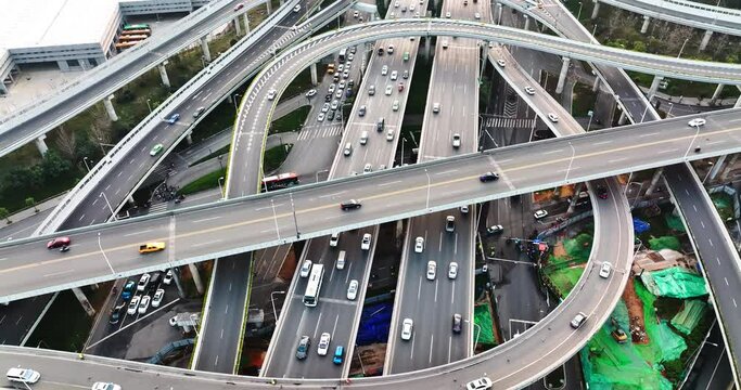 High angle view of  Chinese capital construction that many vehicles rushing through busy structure highways and roads in morning. Aerial photo of heavy traffic in daily working hours.