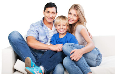 Smiling family sitting at sofa isolated on white background