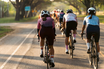 Female cyclists riding bicycles with a group of friends