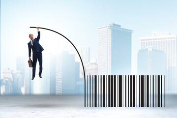 Businessman jumping over bar code in pole vaulting