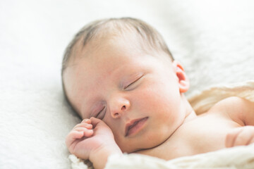 Cute newborn baby lying on a developing rug. Love baby. Newborn baby