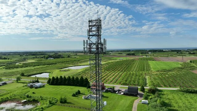 Aerial drone footage of cell phone tower in the summer.