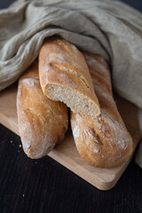 Fresh French home made Baguette Bread on dark background