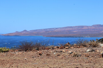 Bay of the Sea of Cortez with the seaside in the background with reddish rocks