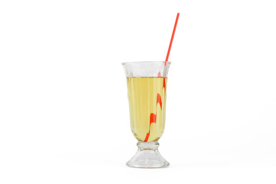 yellow apple-flavored Carbonated Drinks in Tall Glass  with a red straw
