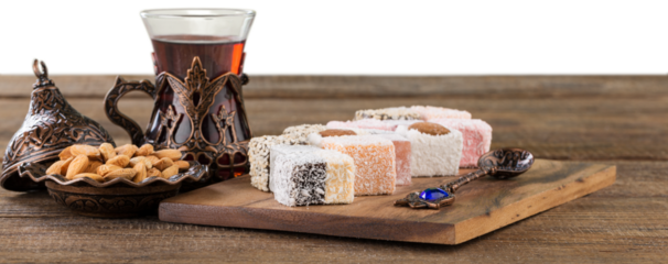 Arabic traditional sweets and berry with tea on plate