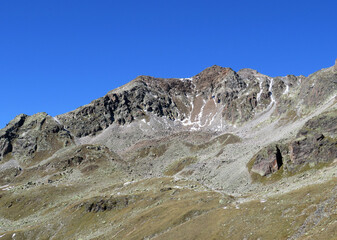 Rocky mountain peak Radüner Rothorn or Raduener Rothorn (3021 m) in the Albula Alps and above the alpine valley Val Grialetsch, Zernez - Canton of Grisons, Switzerland (Kanton Graubünden, Schweiz)