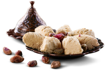Bronze plate with date nuts and arabian sweet on the background. Ramadan kareem.