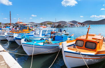 Greece. Crete. Scenic view of Elounda Marina with traditional Greek bright fishing boats on the...