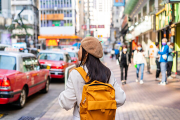 Young woman traveler walking in the Mong Kok in Hong Kong, Mong Kok is one of the major shopping...