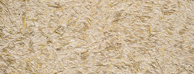 Clay and straw adobe mud texture background. Eco-friendly building material