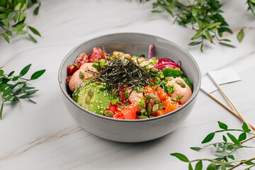 Portion of gourmet salmon poke bowl with vegetables