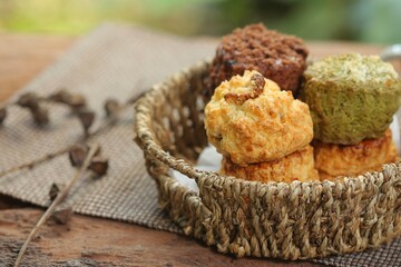 Delicious scone recipe serve with jam on the garden background. Selective focus and free space for text.