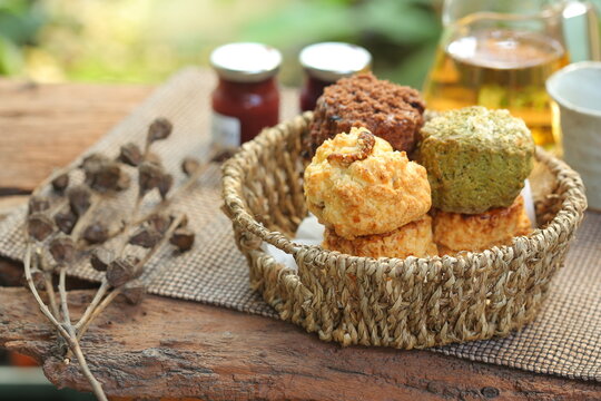 Delicious scone recipe serve with jam on the garden background. Selective focus and free space for text.