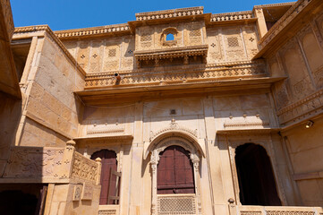 Jaisalmer fort, Rajasthan, India - 15.10.2019 : Sandstone made beautiful balcony, jharokha, stone window and exterior of Rani Mahal or Rani Ka Mahal, inside fort. UNESCO World heritage site.