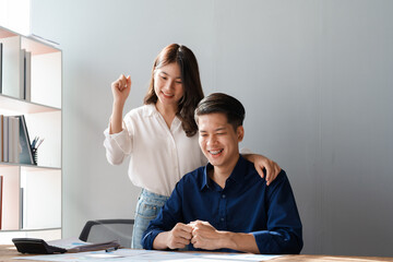 Family couple getting excited about success when they get email with excellent job offer looking at laptop computer with very excited face expressions