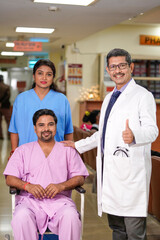 Doctor showing thumps up while patient successful discharge.