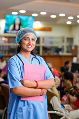 Indian female in surgical uniform standing at hospital.