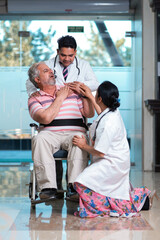 Doctor checking to old man while he is moaning in pain.