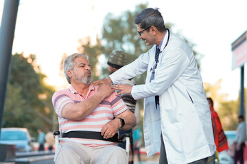 Fototapeta premium Doctor checking to old man while he is moaning in pain.