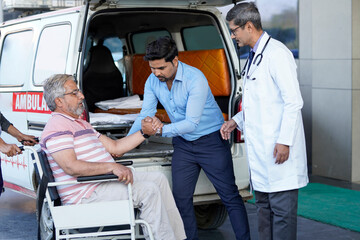 Doctor checking to old man while he is moaning in pain. © PRASANNAPIX