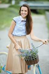 Smiling Hipster Girl and Bike in the City and Copy Space. Urban Youth Lifestyle Concept.
