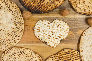 Matzah for Jewish holiday Pesach (Passover) on wooden background.